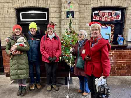 Friends gather by our sustainable Christmas tree